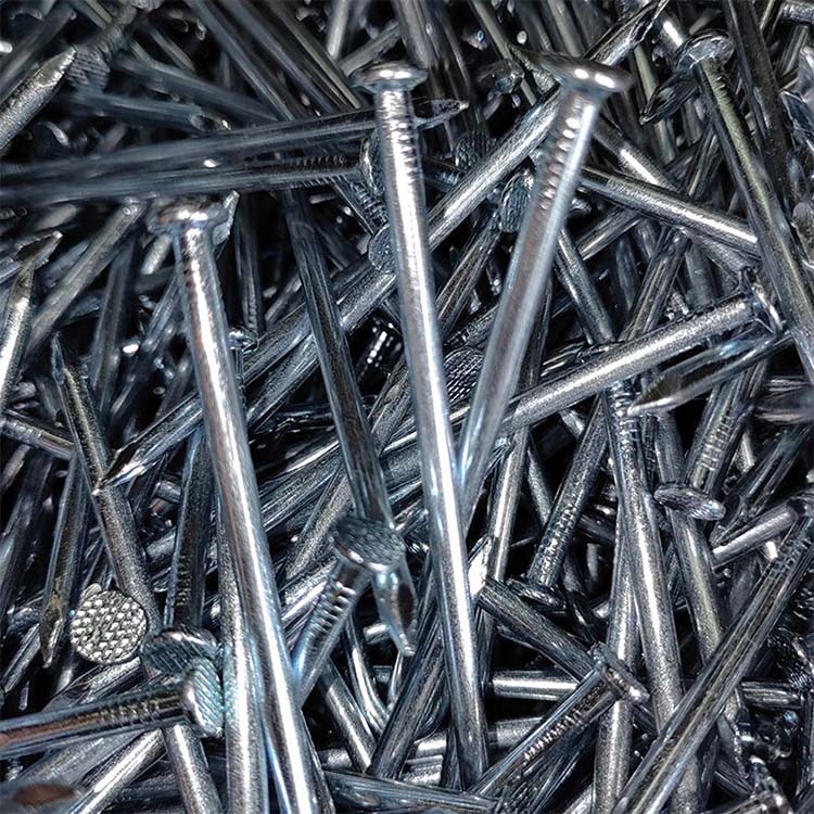 steel nail - YF Metal Tech Close up of a Chaotic Pile of Shiny Steel Nails with Textured Heads Scattered in All Directions