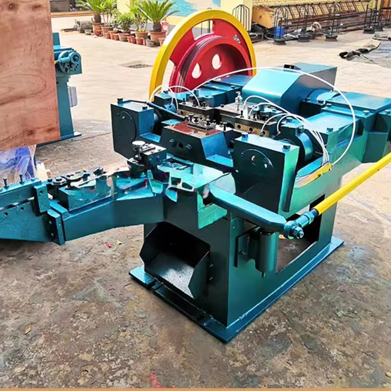 Blue Industrial Metalworking Press with a Large Red and Yellow Flywheel Mounted on a Concrete Outdoor Surface