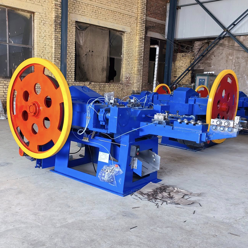 Z94-1C automatic nail making machine - YF Metal Tech Blue Industrial Metalworking Machine with Large Red and yellow Flywheels in a Workshop Metal Shavings Scattered on the Floor Behind It