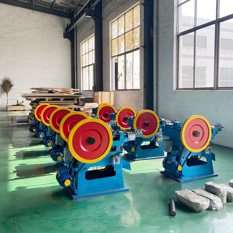 Z94-1C steel wire nail making machine - YF Metal Tech Row of Blue Industrial Grinding Machines with Red and Yellow Wheels Lined Up in a Workshop Green Floor Large Windows and Stacks of Materials in the Background