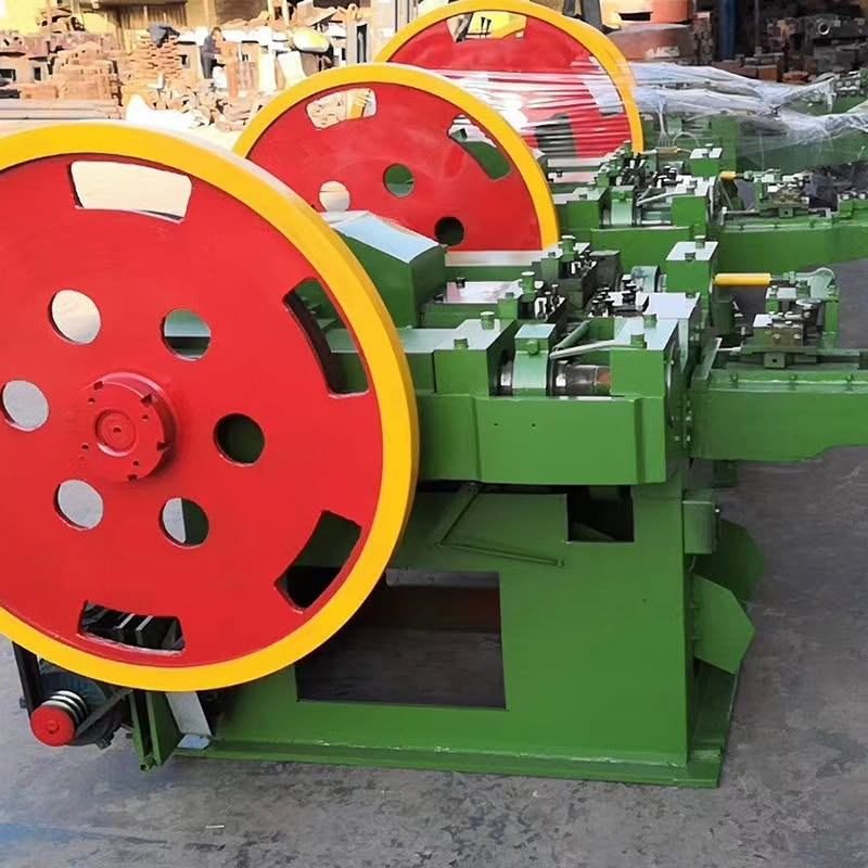 common nail machine manufacturer - YF Metal Tech Row of Green Industrial Machines with Large Red Flywheels with Yellow Rims in a Factory Setting